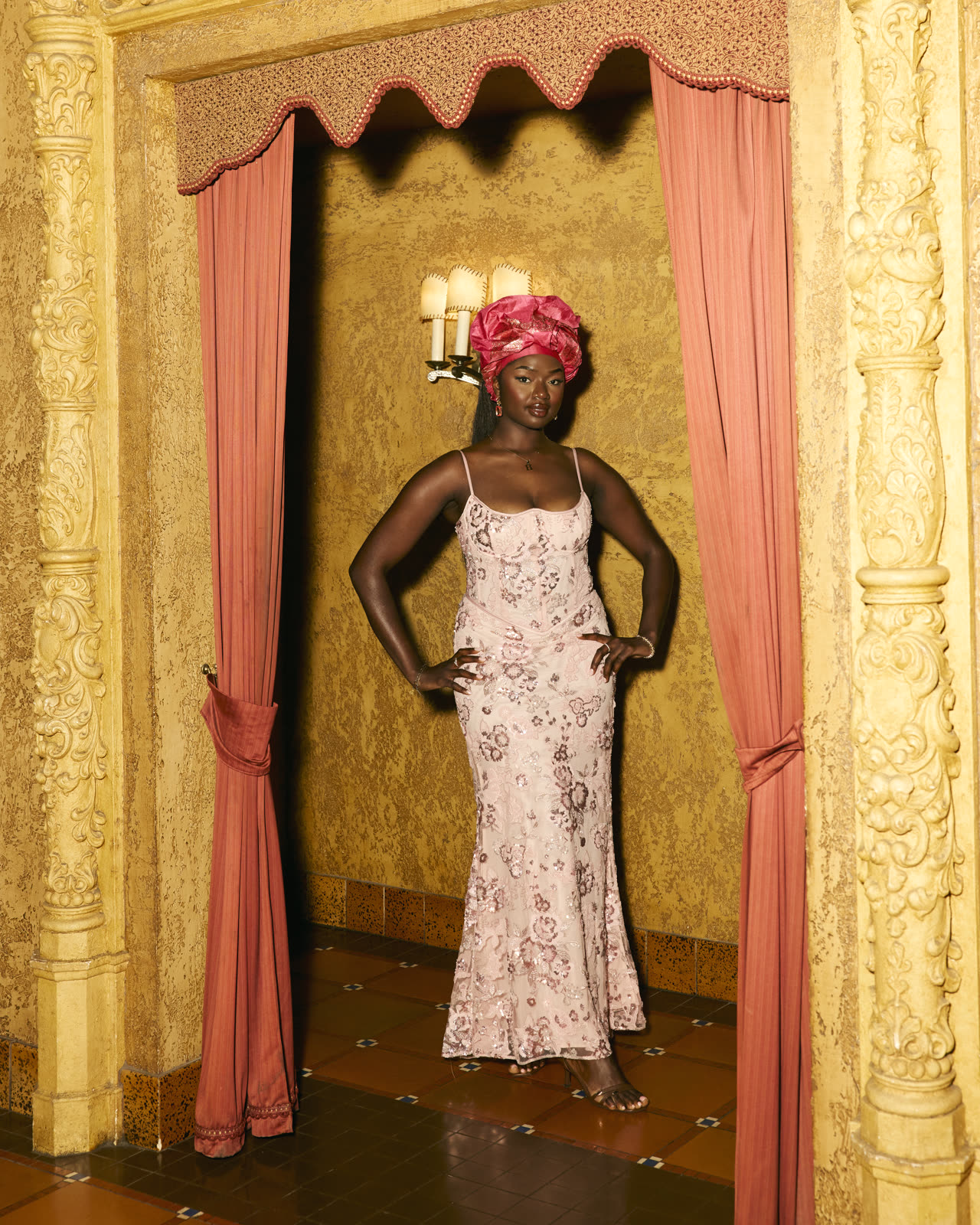 Guest in a blush gown and headwrap